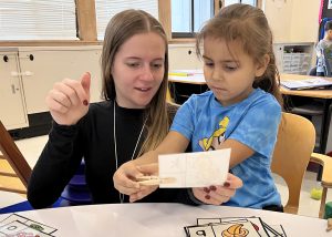 An aide helps a student