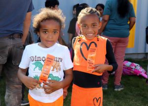 Runners smile while holding their ribbons