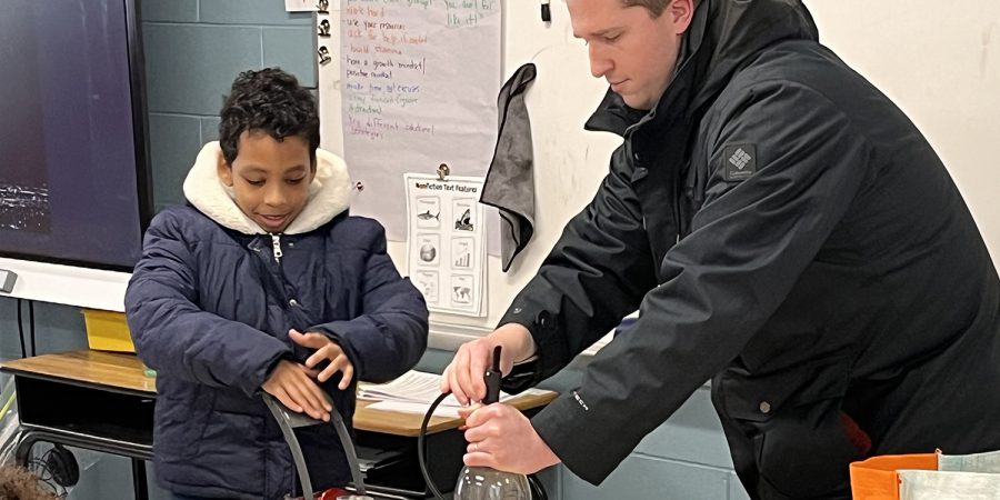 Student and meteorologist perform a lab