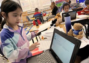 A student looks at a computer