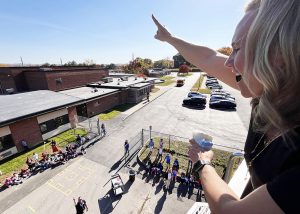 Principal from on top of the ladder truck counts as students on the ground watch