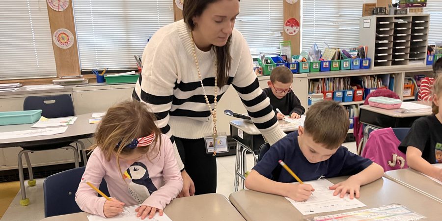 A teacher with two students