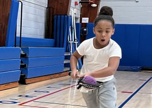 young player running with a lacrosse stick