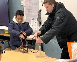 Student and meteorologist perform an experiment